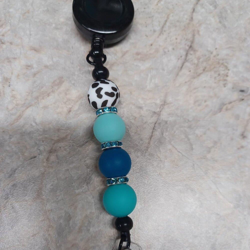 Cow print w/ Teal Badge Reel
